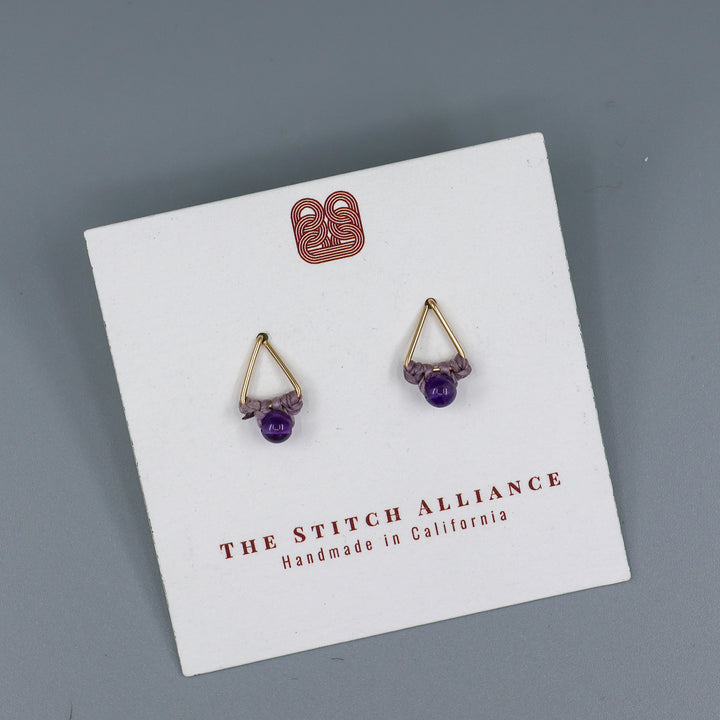 handmade gold fill amethyst triangle stud earrings on a white card with gray background