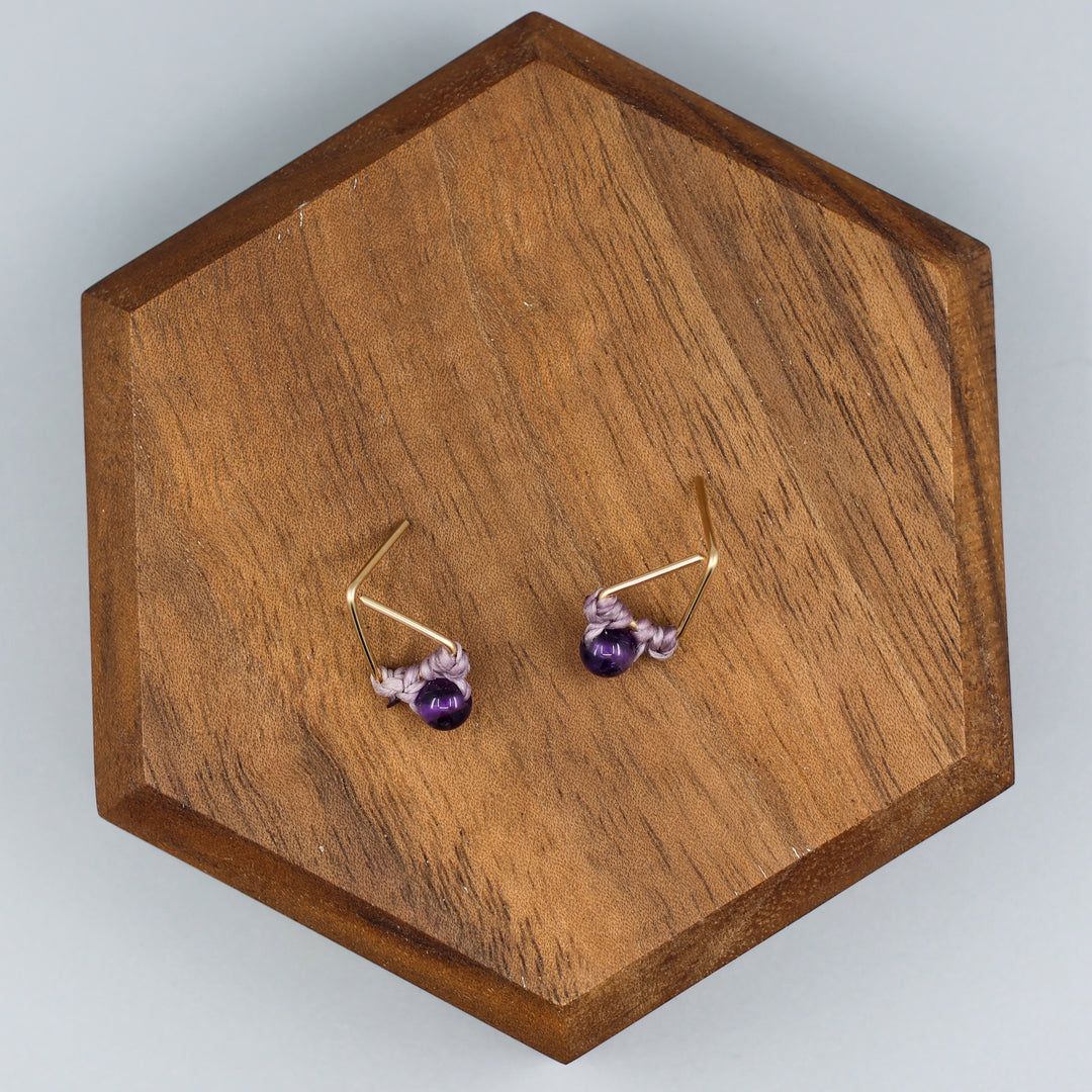 handmade gold fill amethyst triangle stud earrings overhead view