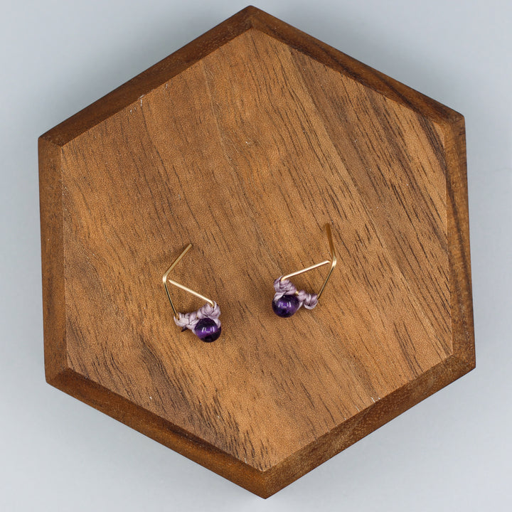 handmade gold fill amethyst triangle stud earrings overhead view