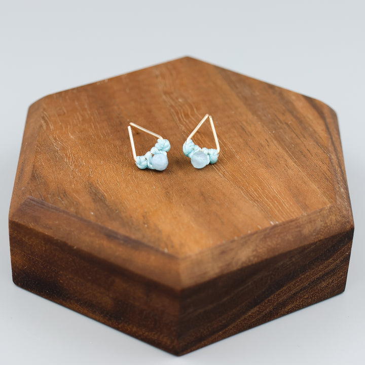 handmade gold filled triangle stud earrings with aquamarine beads overhead view