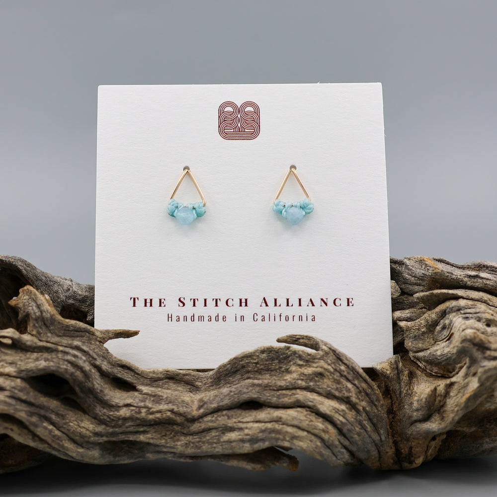 handmade gold filled triangle stud earrings with aquamarine beads on a white card