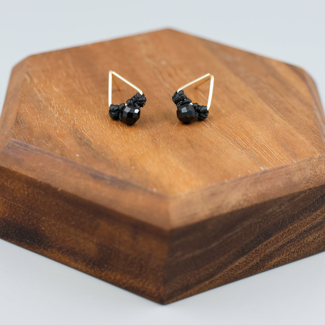 handmade triangle shaped earrings in gold fill with a black spinel bead detail view