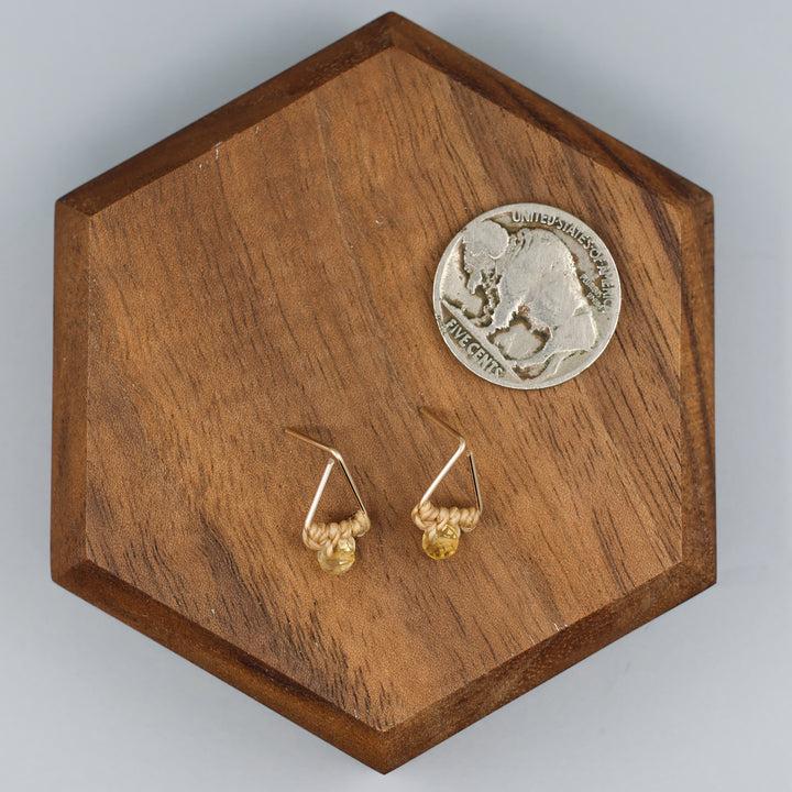 handmade gold fill  triangle stud earrings with a citrine bead with a nickel for size comparison