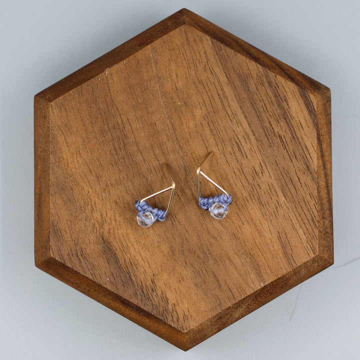 handmade gold fill  triangle stud earrings with a clear quartz beads overhead view