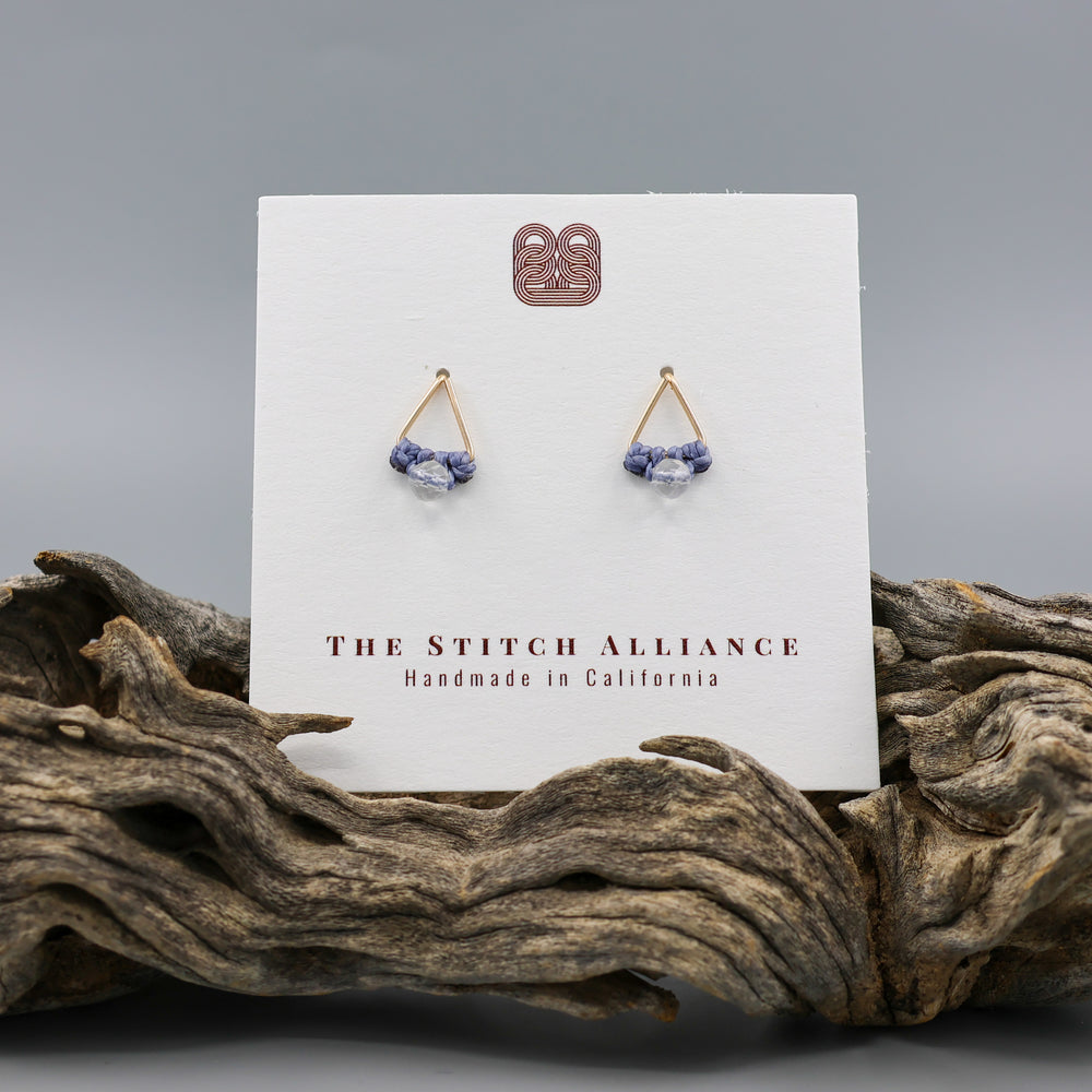 handmade gold fill  triangle stud earrings with a clear quartz beads on a white card