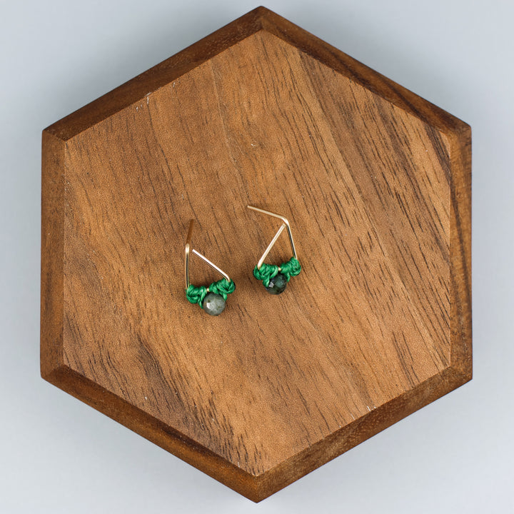 handmade gold fill  triangle stud earrings with emerald beads overhead view