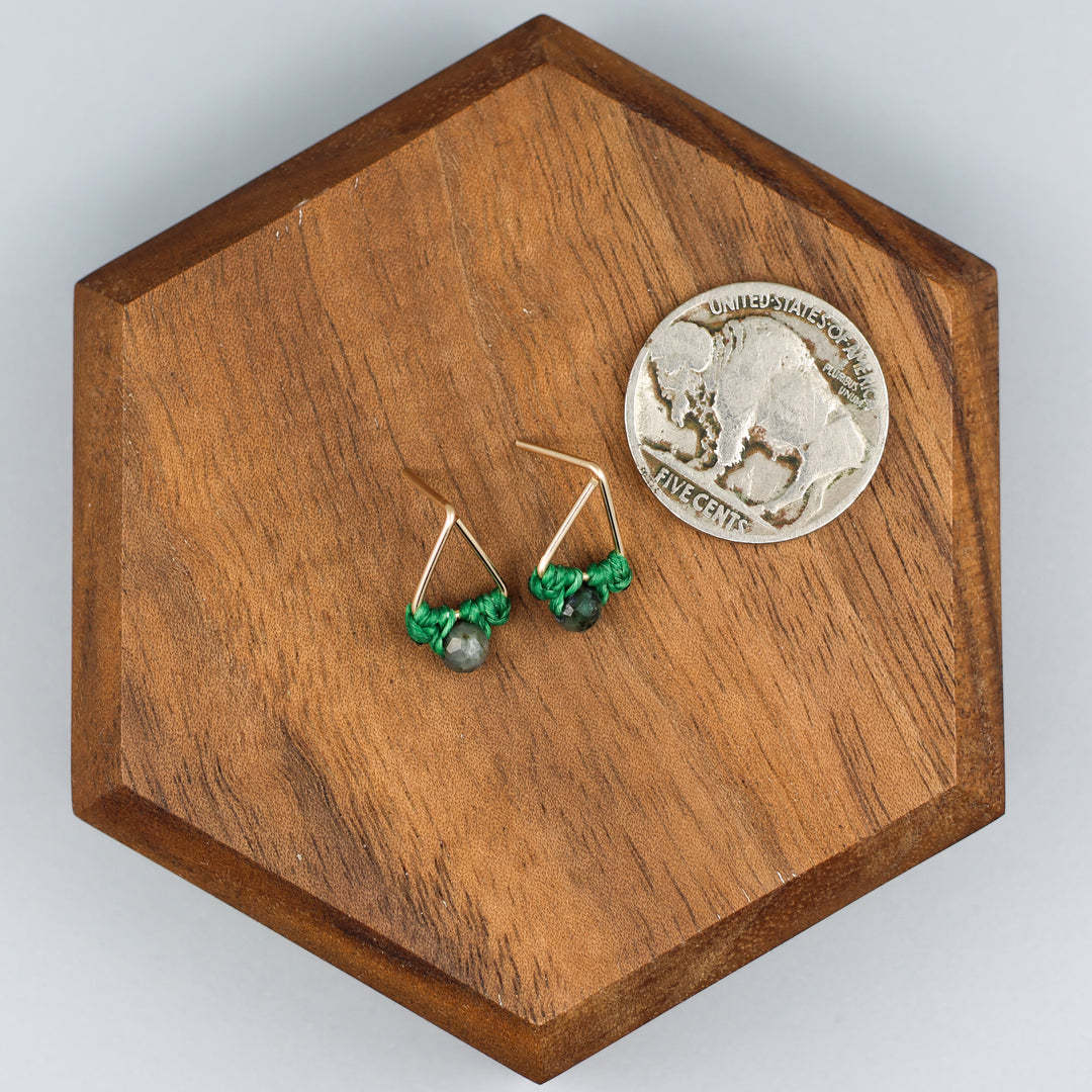 handmade gold fill  triangle stud earrings with emerald beads with a nickel for size comparison