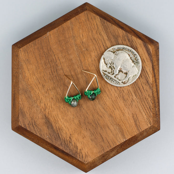 handmade gold fill  triangle stud earrings with emerald beads with a nickel for size comparison