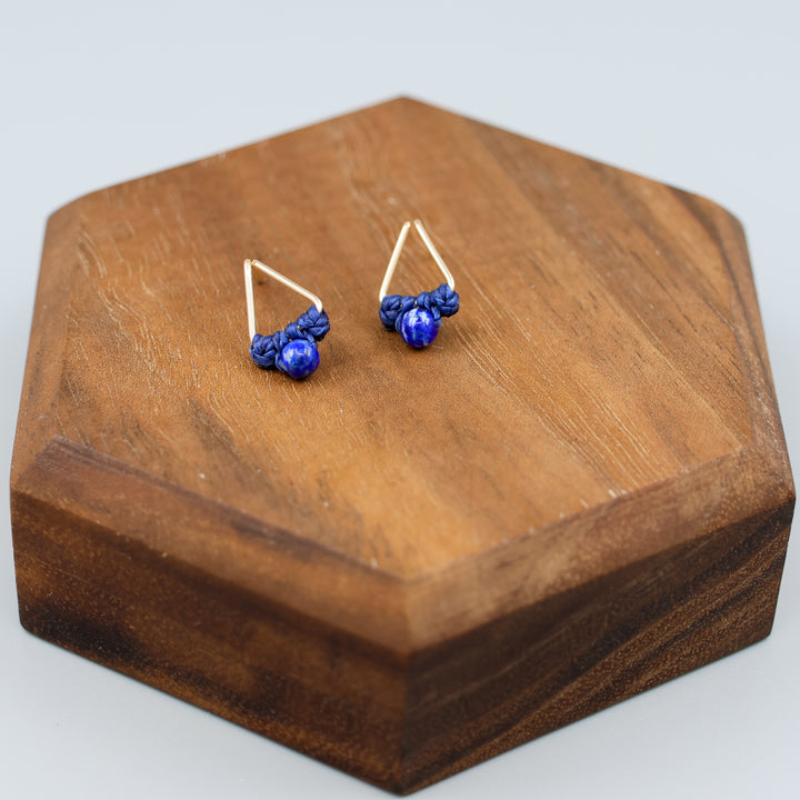 handmade triangle shaped earrings in gold fill with a lapis lazuli bead overhead view