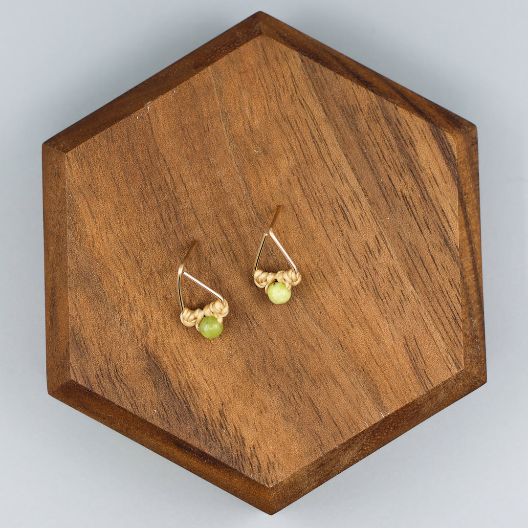 handmade gold fill  triangle stud earrings with peridot beads overhead view