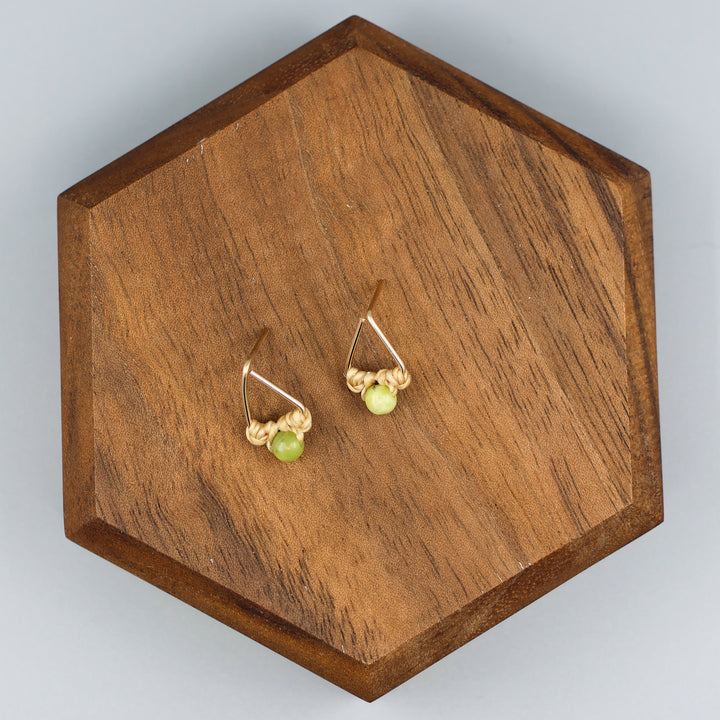 handmade gold fill  triangle stud earrings with peridot beads overhead view