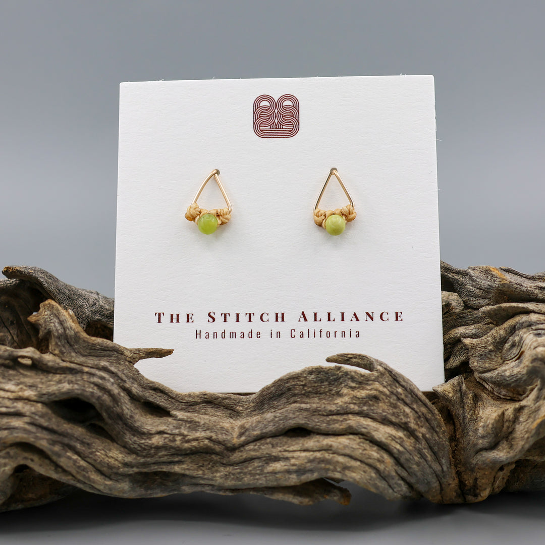 handmade gold fill  triangle stud earrings with peridot beads on a white card