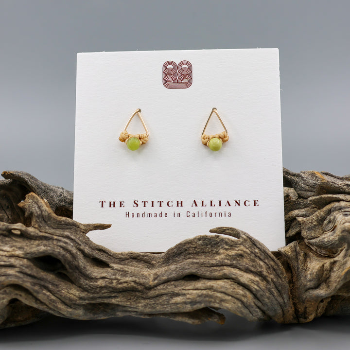 handmade gold fill  triangle stud earrings with peridot beads on a white card