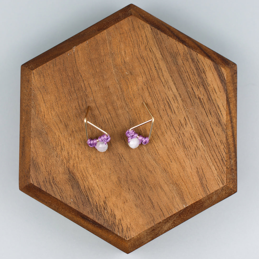 handmade triangle shaped earrings in gold fill with a rainbow moonstone bead overhead view