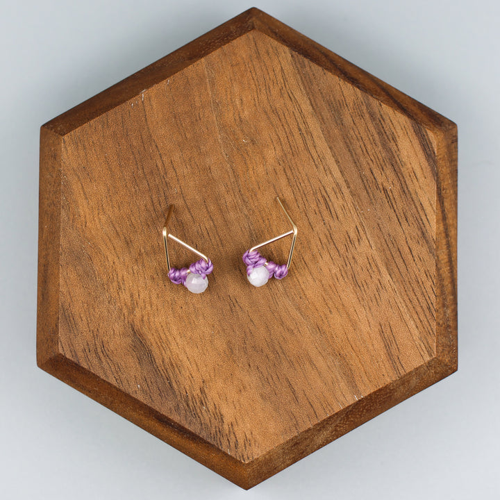handmade triangle shaped earrings in gold fill with a rainbow moonstone bead overhead view