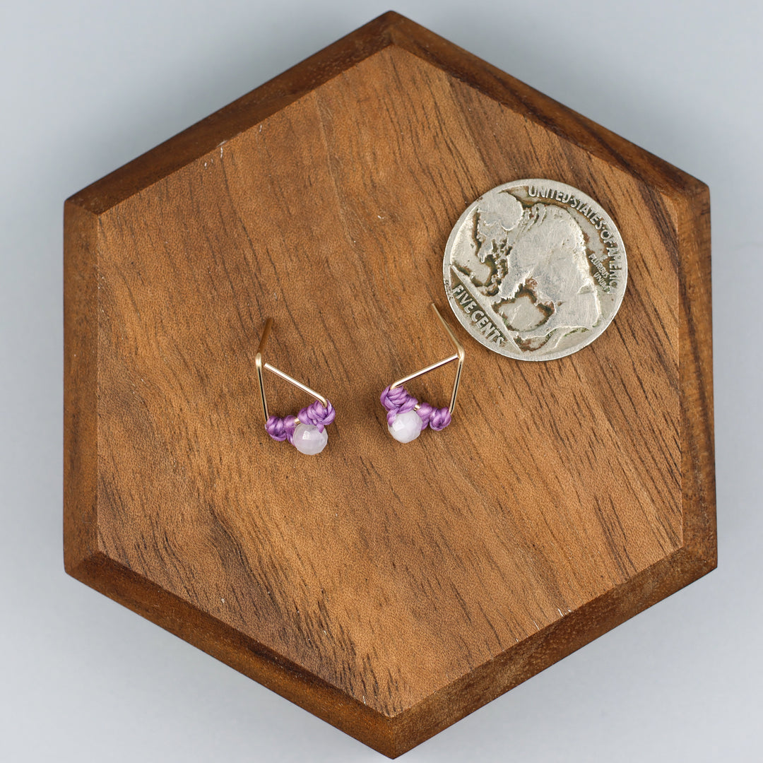 handmade triangle shaped earrings in gold fill with a rainbow moonstone bead with a nickel for size comparison