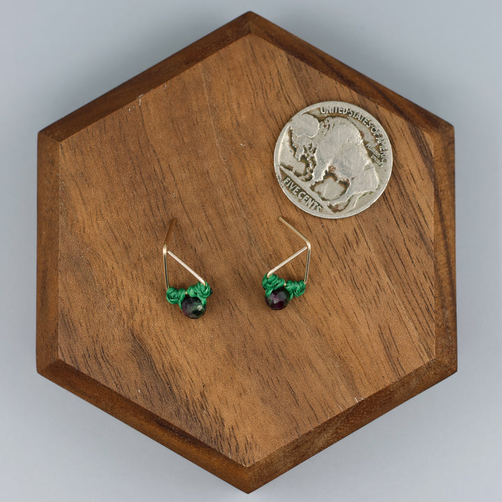 handmade gold filled triangle stud earrings with ruby zoisite beads with a nickel for size comparison
