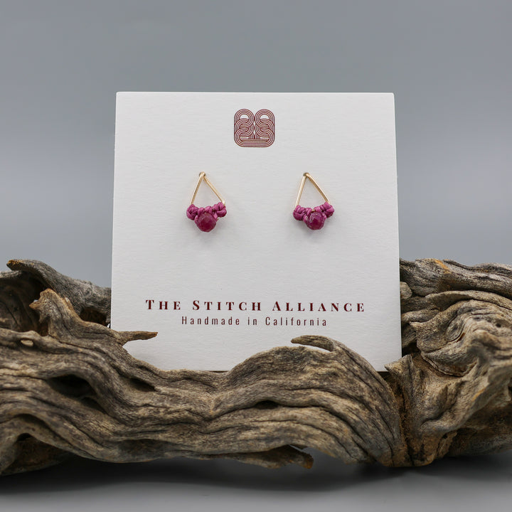 handmade gold filled triangle stud earrings with ruby beads  on a white card