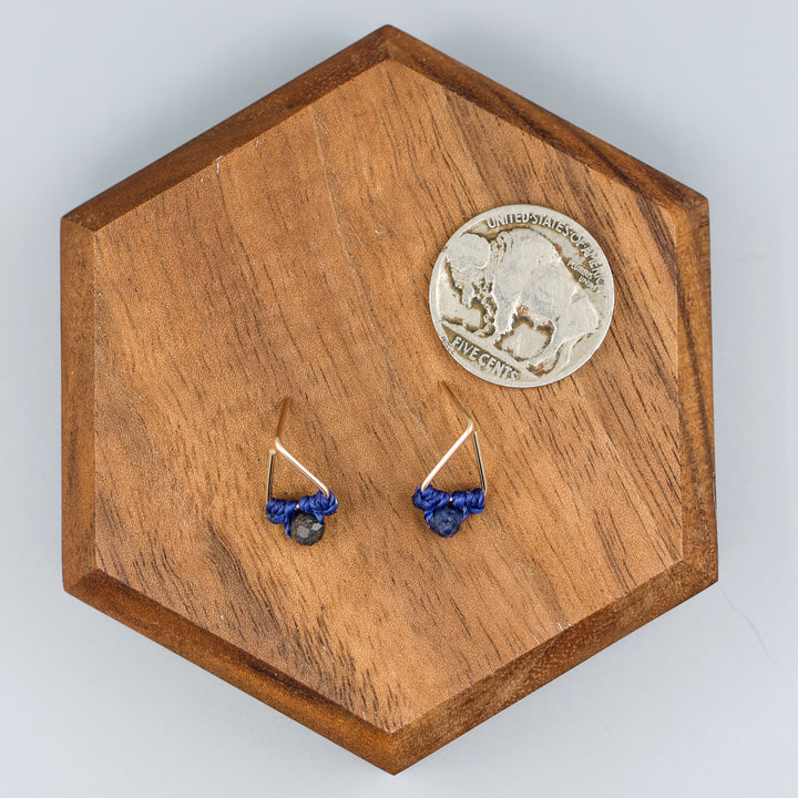 handmade gold filled triangle stud earrings with sapphire beads  with a nickel for size comparison