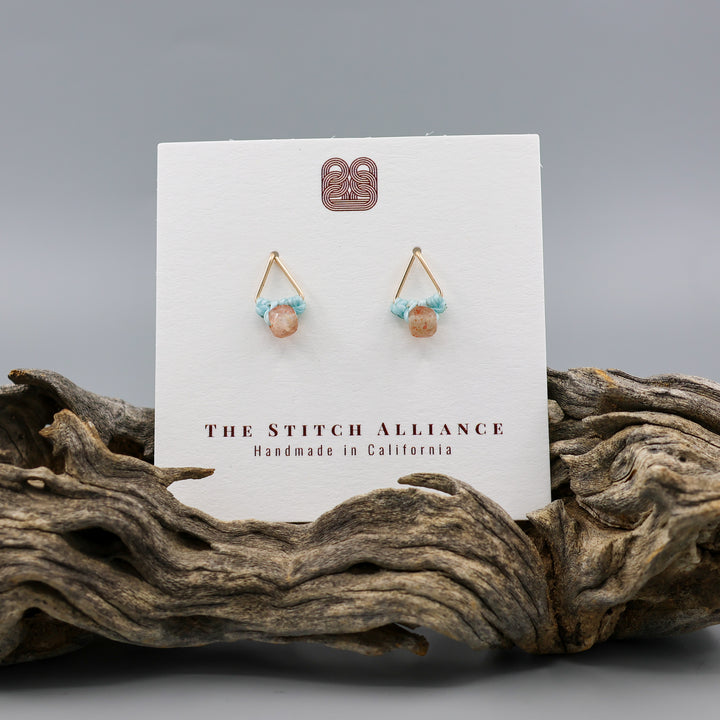 handmade triangle shaped earrings in gold fill with a sunstone bead on a white card