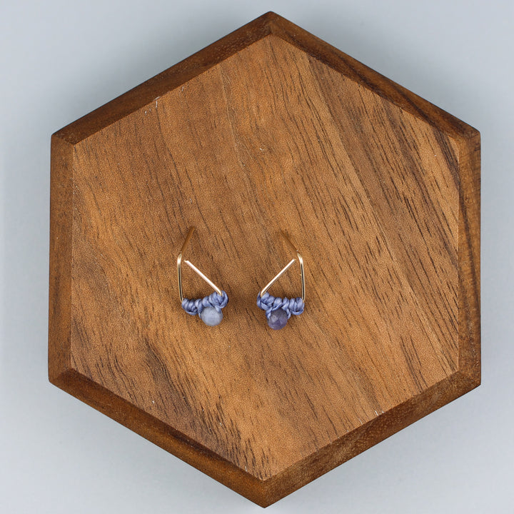 handmade gold filled triangle stud earrings with tanzanite beads  overhead view