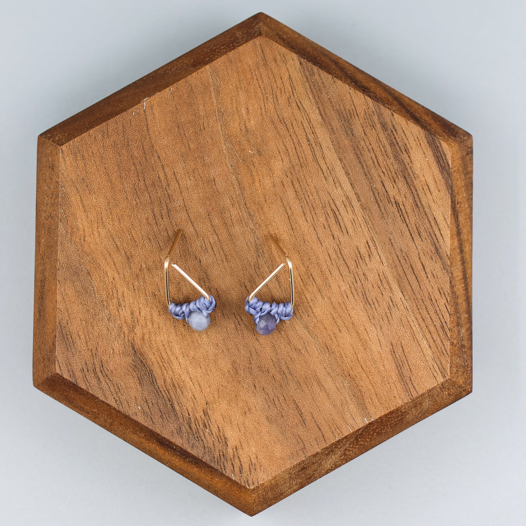 handmade gold filled triangle stud earrings with tanzanite beads  overhead view