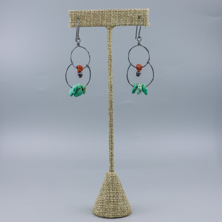 handmade double hoop earrings with turquoise beads and oxidized sterling silver on a linen hanger