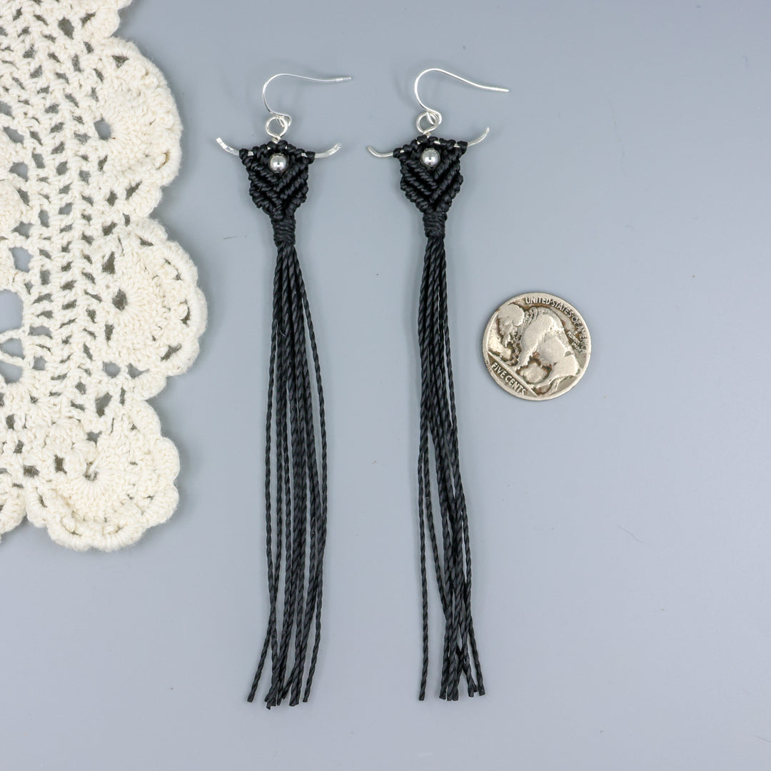 Long, handmade macrame statement earrings in black with sterling silver with a nickel for size comparison