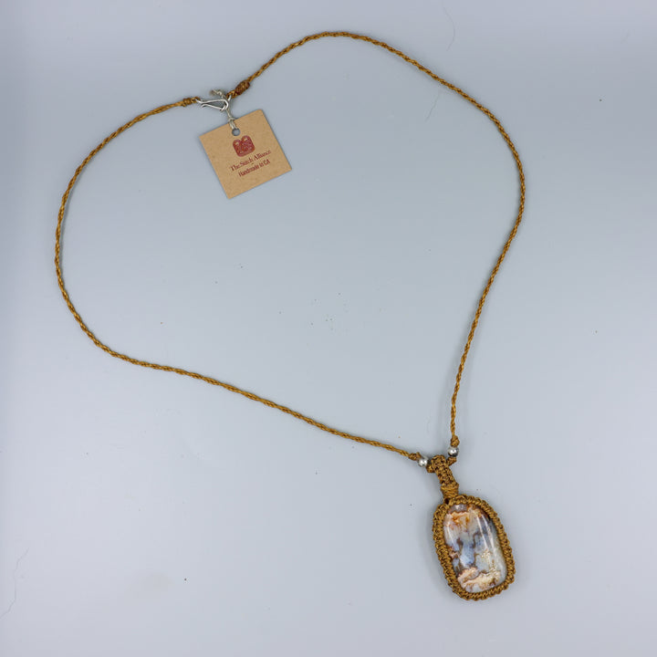 handmade Agate macrame necklace on gray background