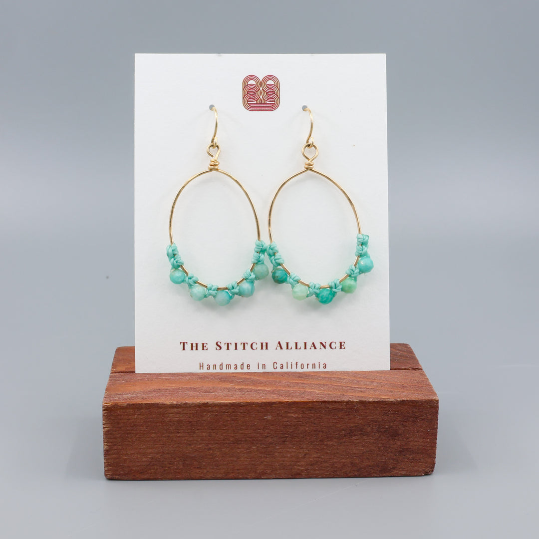 handmade gold hoops with  amazonite beads on a white card