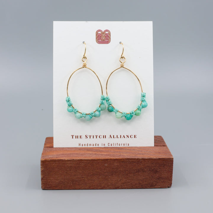 handmade gold hoops with  amazonite beads on a white card