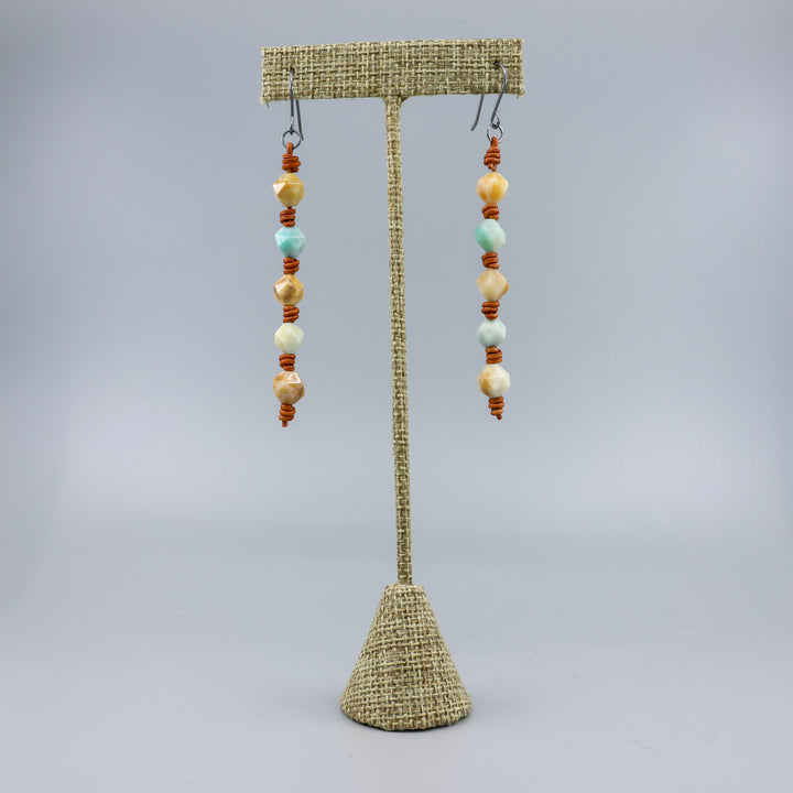 handmade amazonite and leather barrell knot earrings with handmade oxidized sterling silver ear wires on a linen hanger