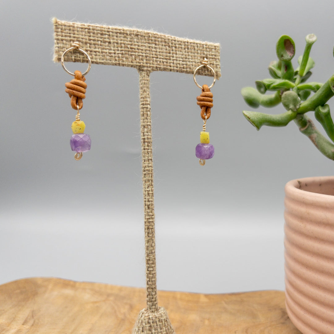 sundance earrings amethyst and jade gold filled earrings with leather knotting shown hanging