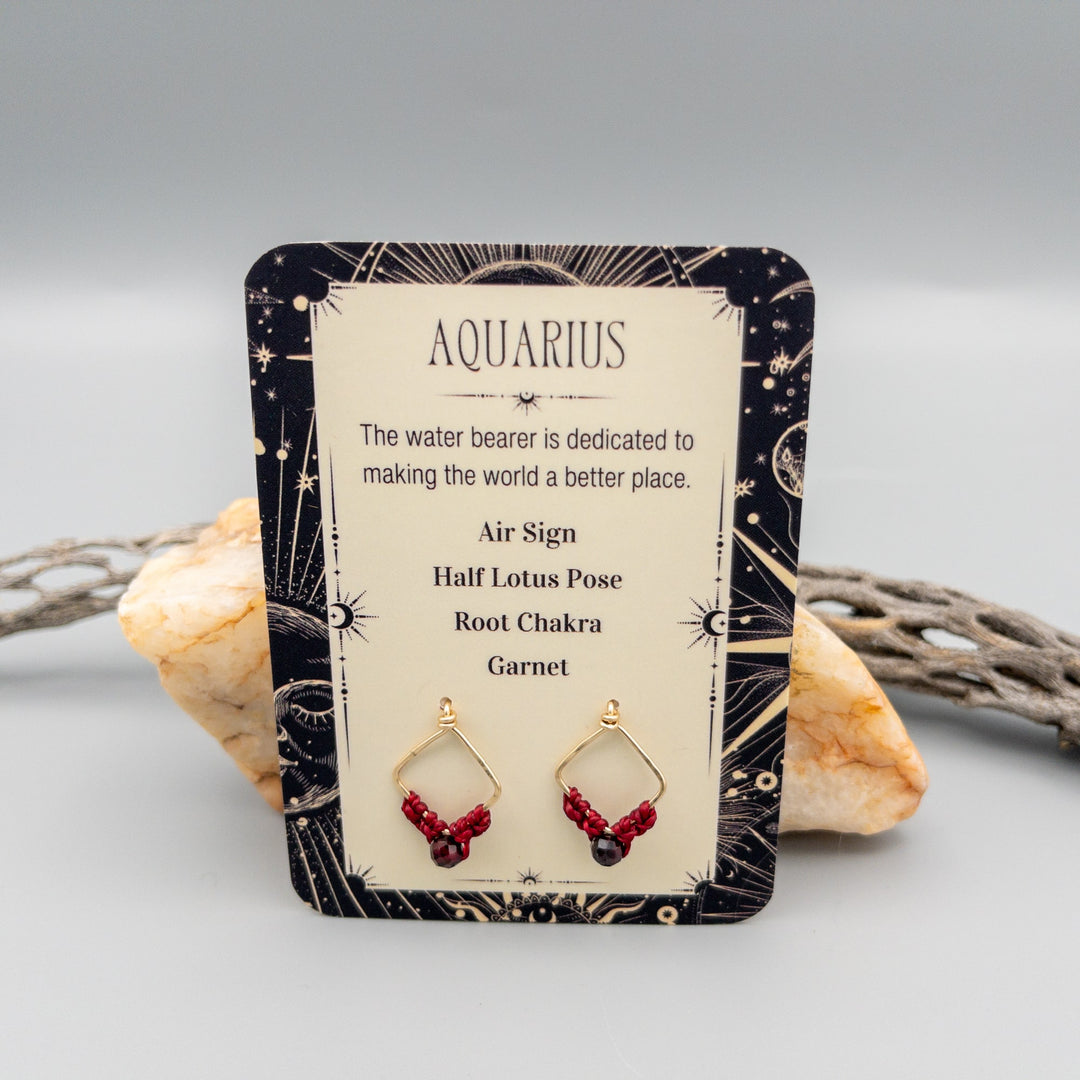 Aquarius garnet gold filled zodiac earrings on a gift card