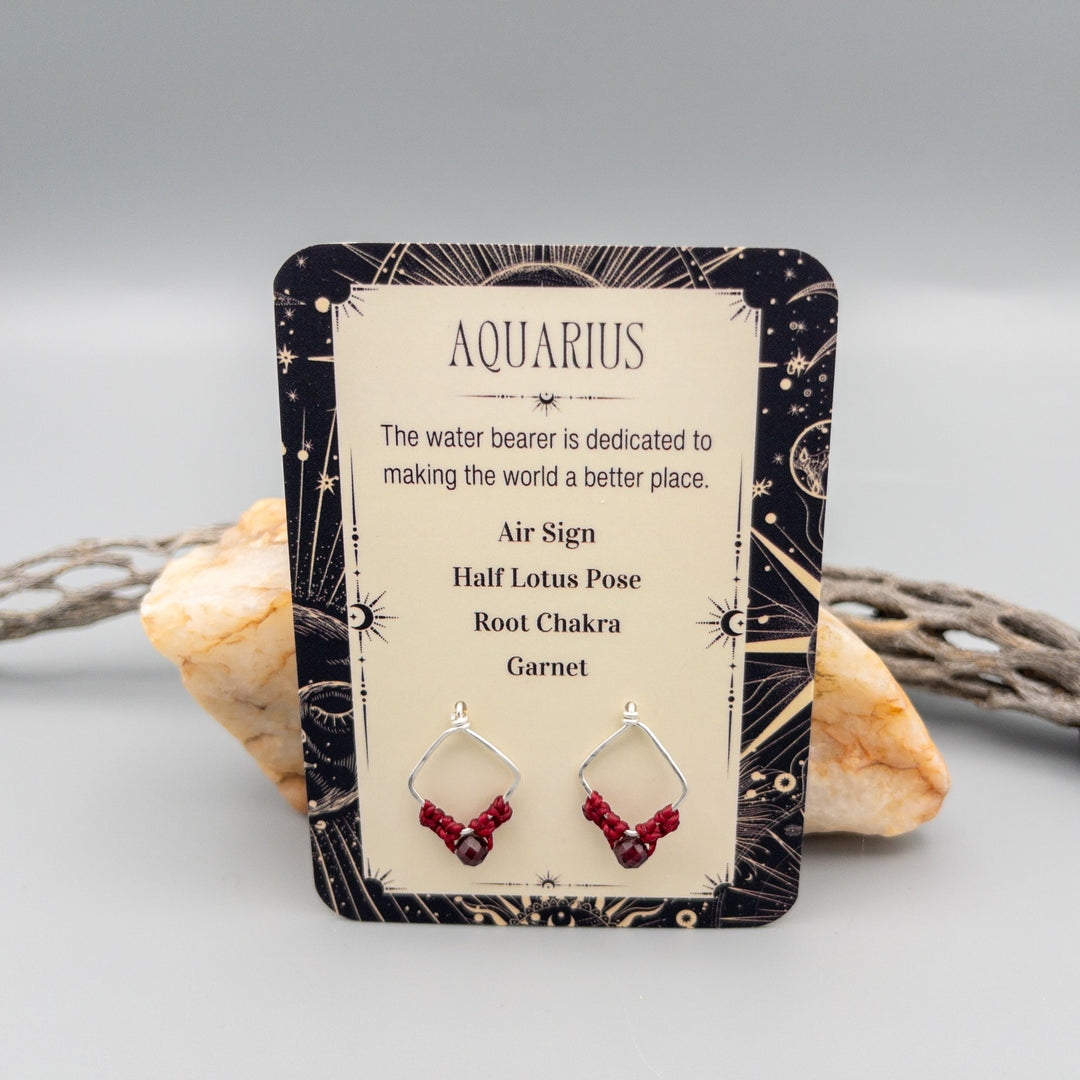 Aquarius garnet earrings in sterling silver showing the front of the gift card