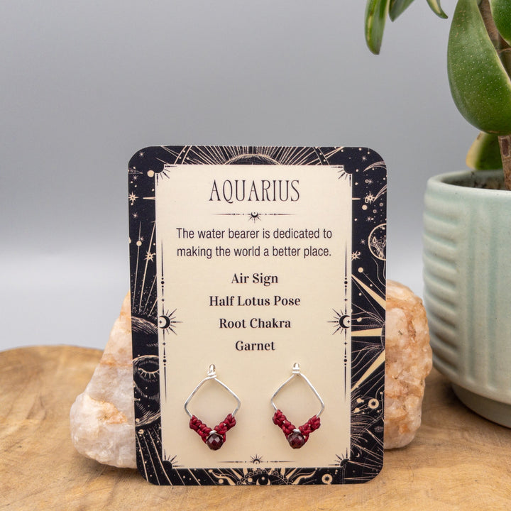 Aquarius garnet earrings in sterling silver on a gift card