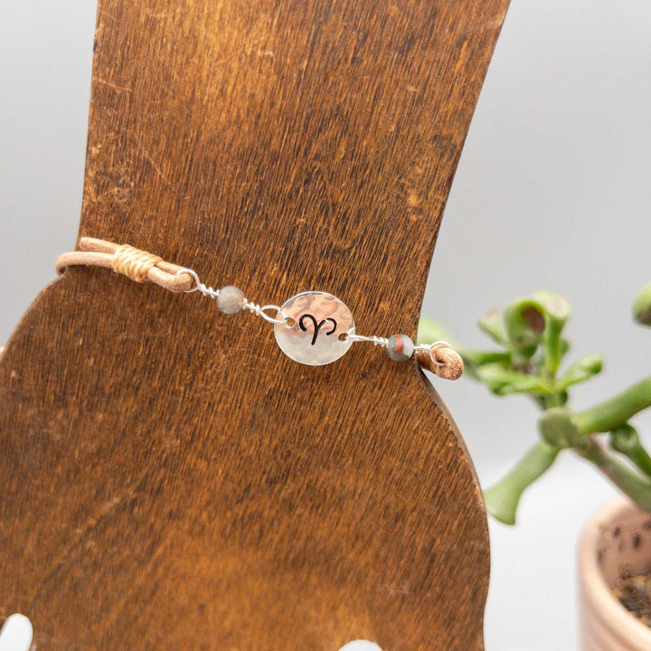 Aries bracelet - hand stamped sterling silver with bloodstone beads on a wood hand display