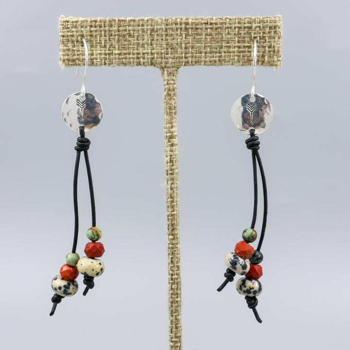 Arrow stamped sterling silver and leather earrings with jasper beads close up view