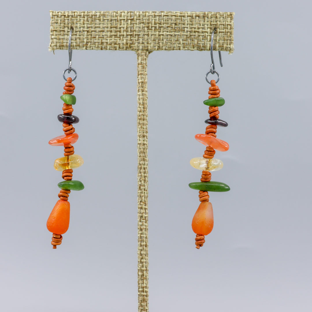 handmade agate, jade, citrine, and garnet leather dangle earrings with oxidized sterling silver ear wires shown on a linen display hanger