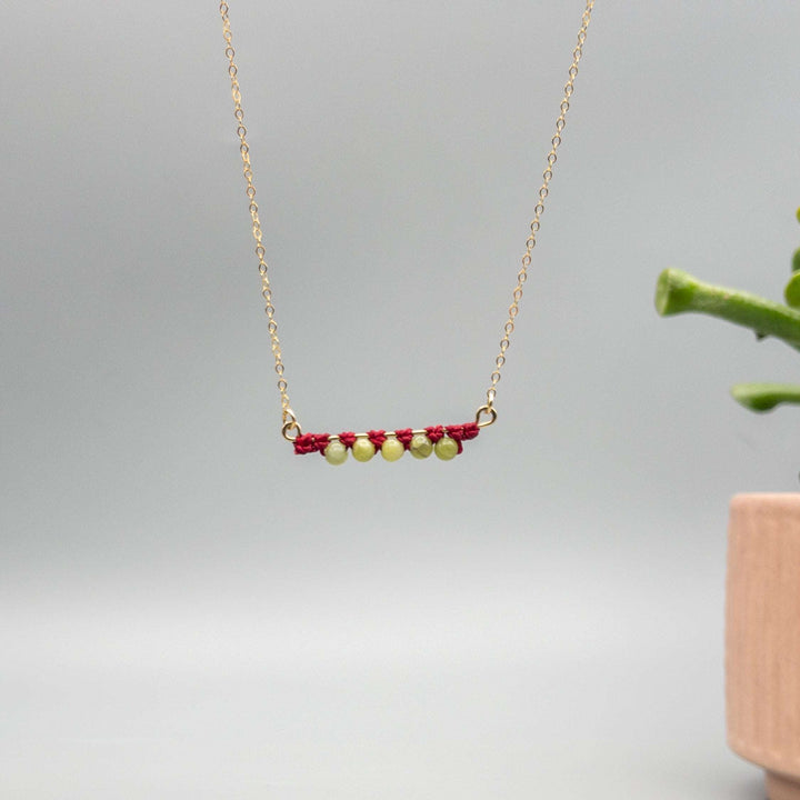 14k gold filled bar necklace with peridot beads and macrame