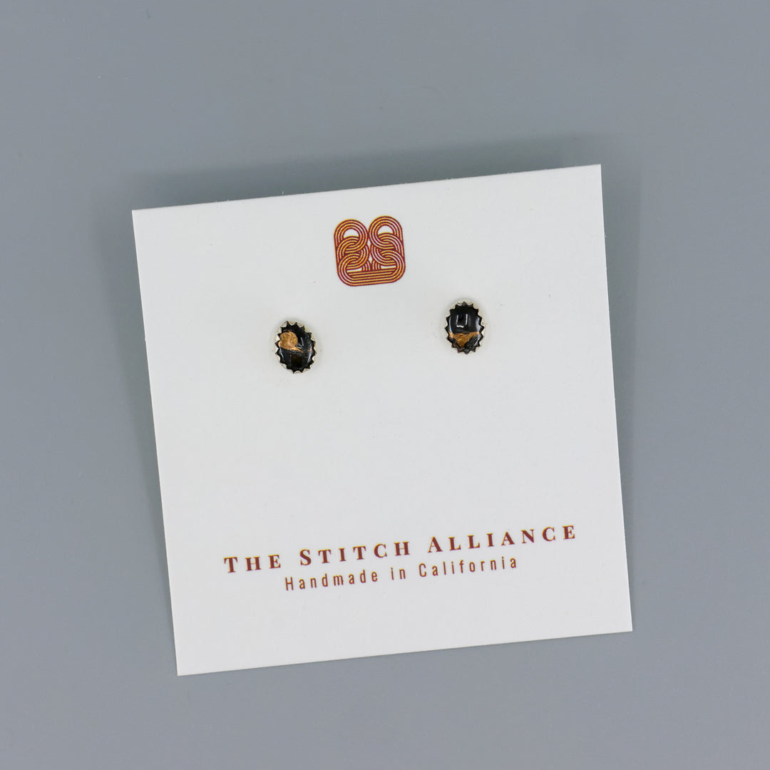 handmade black copper obsidian stud earrings on a gray background
