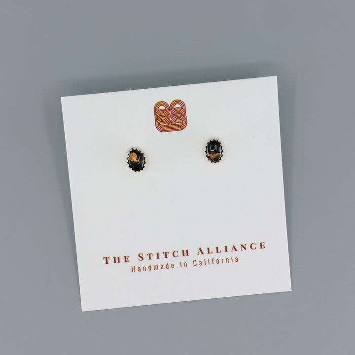 handmade black copper obsidian stud earrings on a gray background