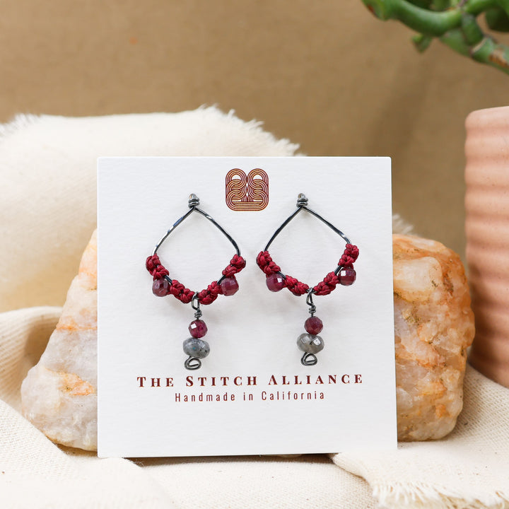 garnet and larvikite oxidized sterling silver earrings on a white card