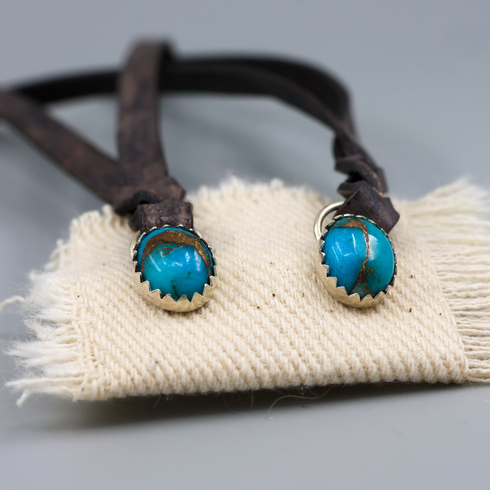 handmade turquoise earrings with distressed black leather fringe detail view