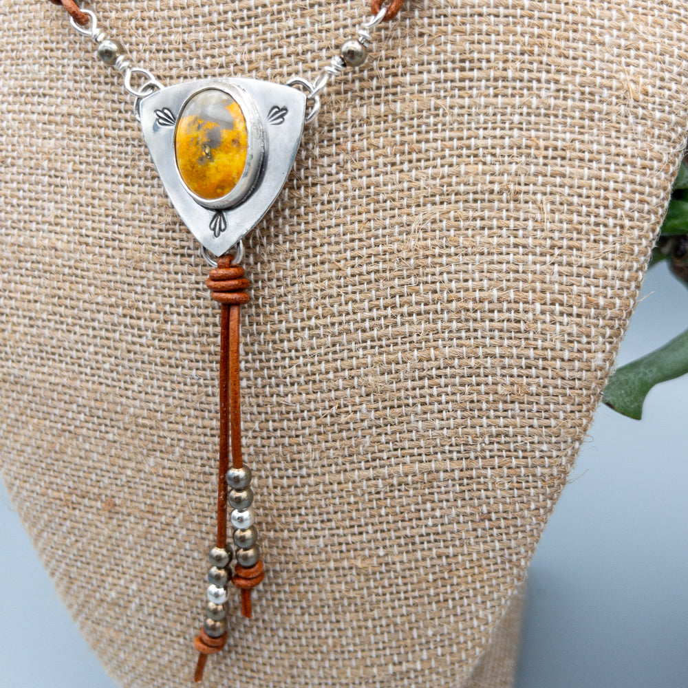 detail of bumblebee jasper sterling silver pendant with leather necklace and fringe