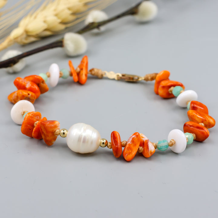 beach inspired handmade bracelet with pearl, spiny oyster, amaonite, and queen conch beads. Gold fill clasp. 