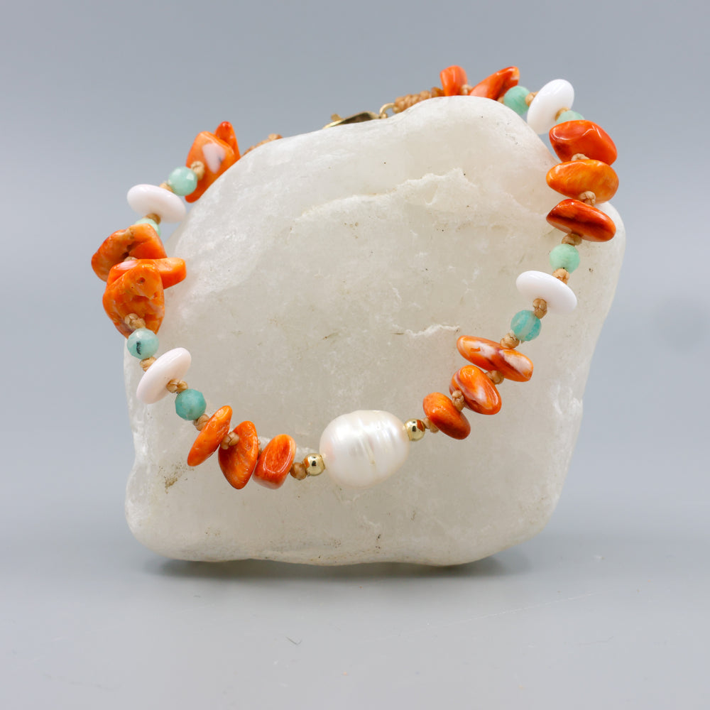 handmade beach inspired bracelet with pearl, spiny oyster, amaonite, and queen conch beads. Gold fill clasp. 