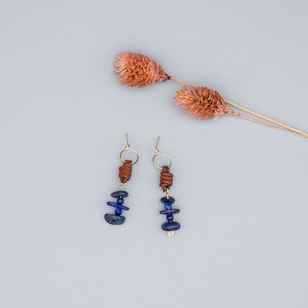 Lapis Lazuli drop earrings in 14k gold fill with natural leather on gray background