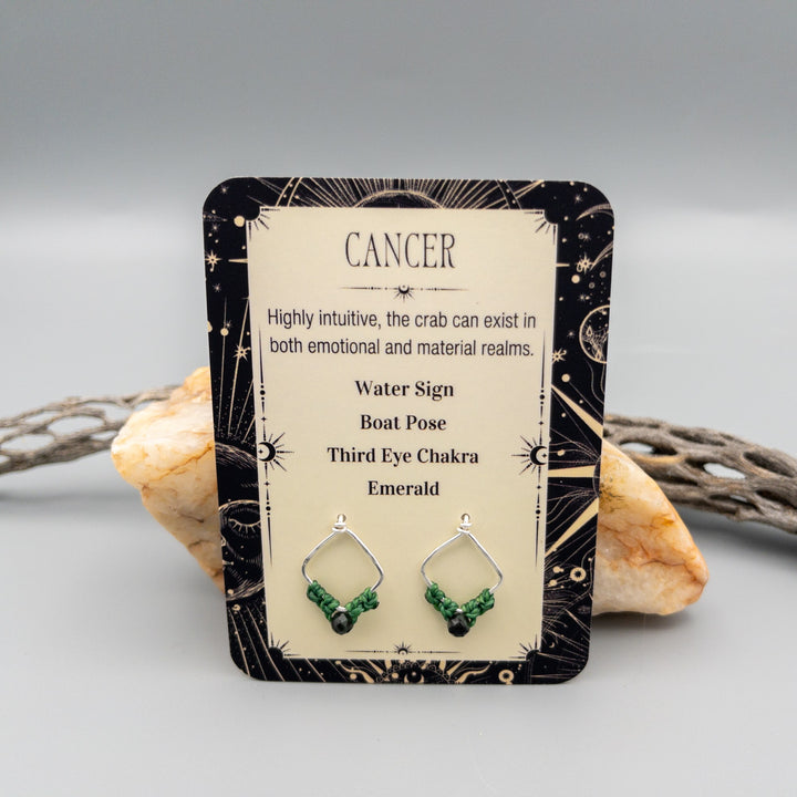 Cancer emerald sterling silver earrings showing the front of the card