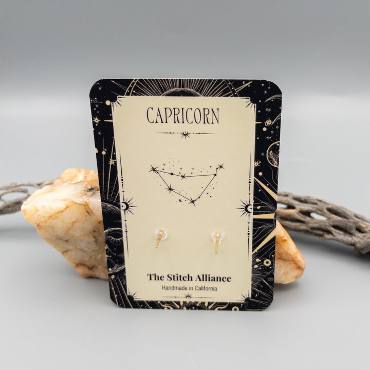 Capricorn ruby earrings gold filled back of card